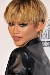 A celebrity named Zendaya in her dark honey blonde pixie bob