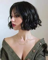 Curly bob with blunt bangs for a classy look