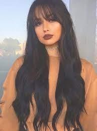 Girl in dark hair in a waist-length cut with bangs