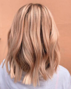 Stunning golden peach balayage on shoulder-length hair