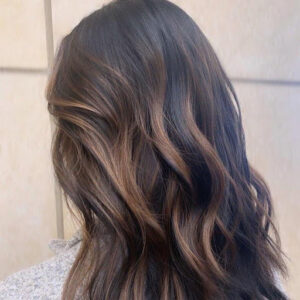 A natural-looking partial balayage on dark Asian hair