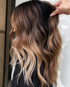 A gorgeous white coffee balayage on dark hair and in medium length