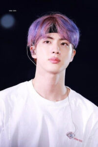 Korean boy group in purple hair with a headband and white shirt