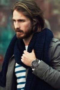 Long hairstyle with beard in a man with blue scarf