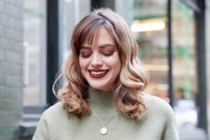 Smiling girl in pinned curl bangs