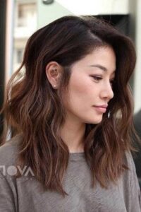 Asian woman in a medium hairstyle with textured waves