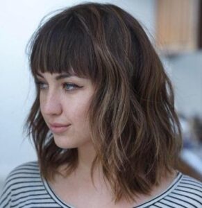 Brown-haired girl in a wavy long bob with bangs