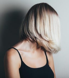 A girl in black top with layered bob haircut